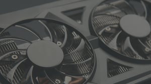 Close-up of a dual-fan workstation GPU cooler, illustrating RTX PRO 6000 Blackwell Max-Q versus 600 W benchmark testing.